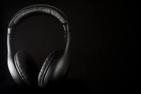 Headphones on a black — Stock Photo, Image