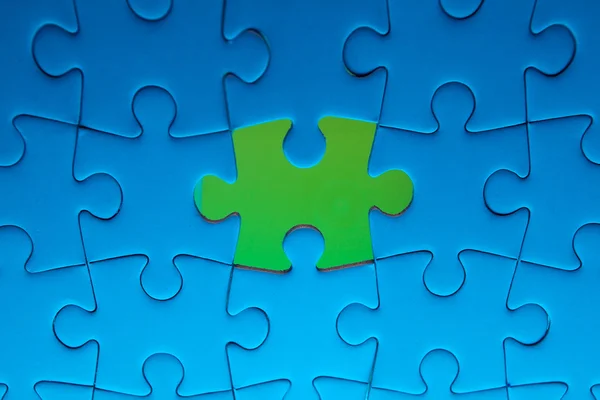 Missing jigsaw puzzle piece with light glow — Stock Photo, Image