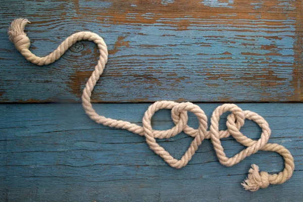 Leash  rope into heart shape on wood — Stock Photo, Image