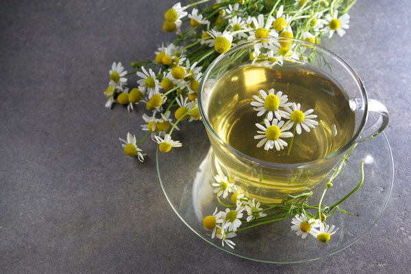 cup of chamomile tea with flowers