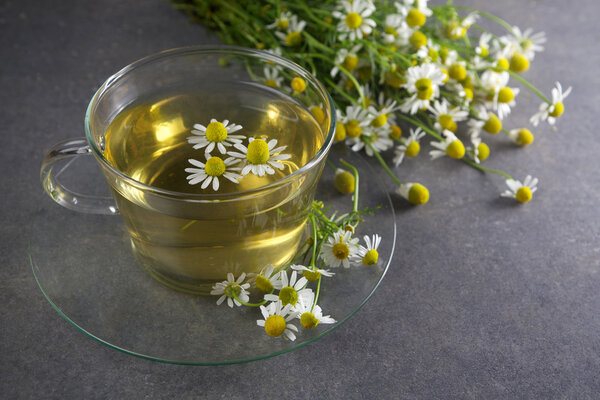 cup of chamomile tea with flowers