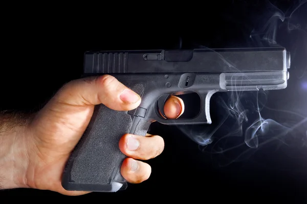 Male hand with a gun — Stock Photo, Image