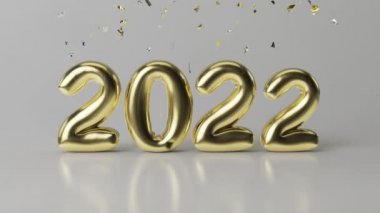 Yeni yıl ve Noel 2022. Gri bir zemin üzerinde altın konfetiyle 2022 altın yazıtları ortaya çıkıyor..