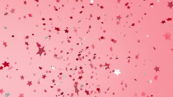 Röda och vita, blanka stjärnor på konfetti flyger från vänster till höger. — Stockvideo