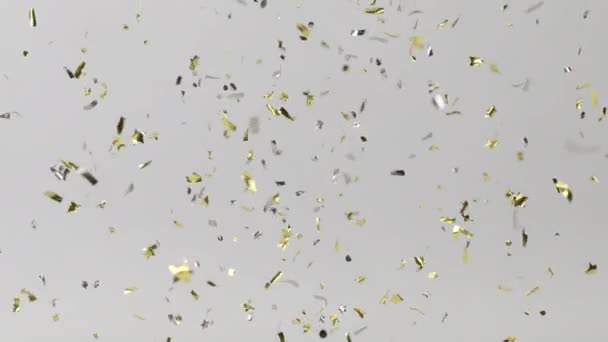 Gouden confetti van verschillende vormen vallen op een grijze achtergrond. 4K animatie met alpha kanaal — Stockvideo
