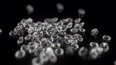 Siyah parlak bir arkaplanda ışıldayan değerli taşlar.