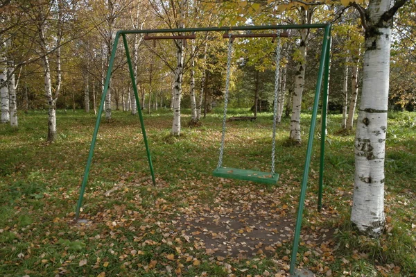 Swing  in  autumn  Park. — Stock Photo, Image