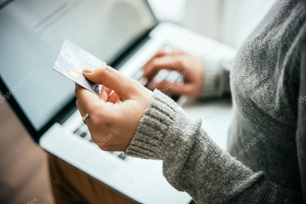 Hands holding plastic credit card