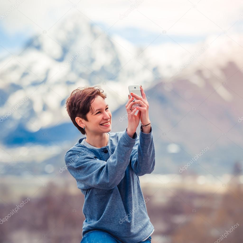 Woman taking pictures on smartphone