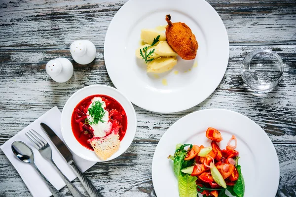 Three plates with lunch dishes — Stock Photo, Image