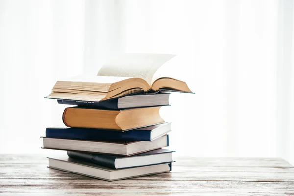 Pile of books on wooden table — Stock Photo, Image