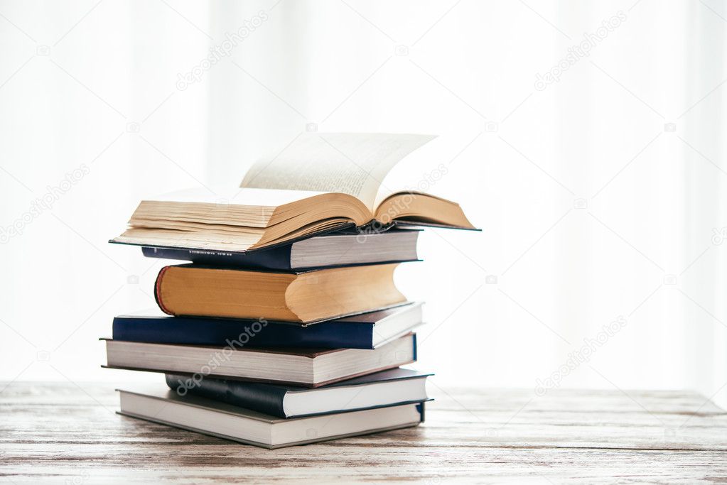 Pile of books on wooden table