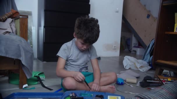 Ребенок сидит на полу с игрушками — стоковое видео