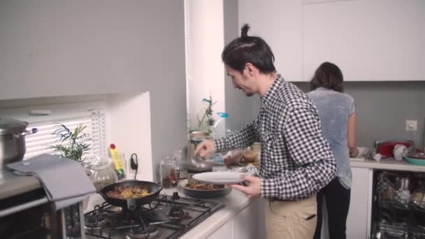 Guy puts food from the frying pan — Stock Video