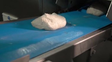 Bread dough on the production line in the baking industry. Production of bakery products.