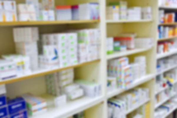 Pharmacy store drugs shelves interior blurred background — Stock Photo, Image