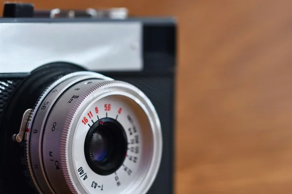 Russian old analog camera on a wooden background.