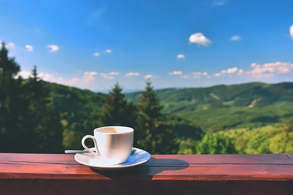 Morning cup of coffee with a beautiful mountain landscape background