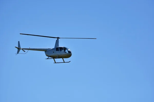 Helicopter flying against the blue sky — Stock Photo, Image