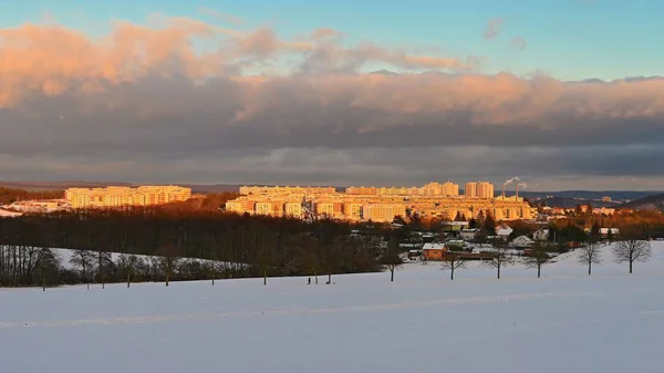 Landscape with houses and snow at sunset. Traditional housing estate. Living in the Czech Republic.