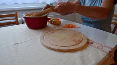 Mutfakta sebze doğrayan ve hazırlayan bir kadın. Yemek ve yemek hazırlama kavramı.