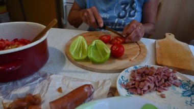 Mutfakta sebze doğrayan ve hazırlayan bir kadın. Yemek ve yemek hazırlama kavramı.