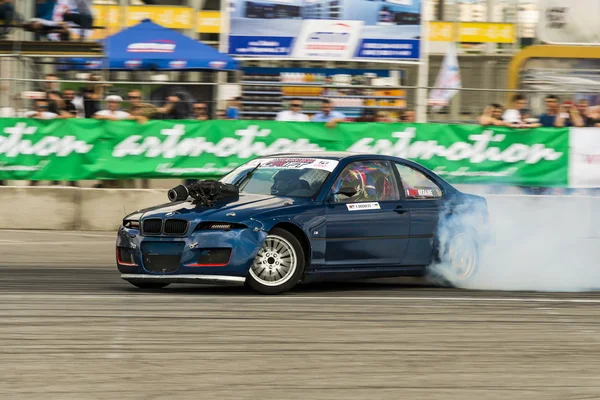 Unknown rider on the car brand BMW overcomes the track — Stock Photo, Image