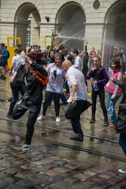 Lviv, Ukrayna - 2 Mayıs 2016: Pazartesi günü Paskalya 'dan sonra belediye binasında kutlama suyu dökülüyor. İnsanlar arasında dans eden kel adamlar.
