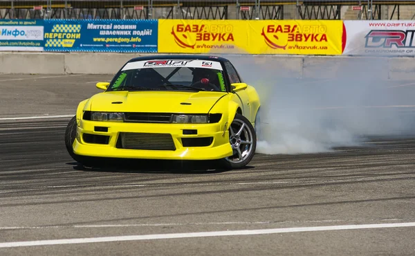 Yellow drift car brand Nissan overcome turn track — Stock Photo, Image