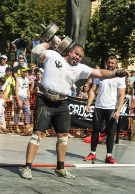 Strongman competitions raises dumbbell hand