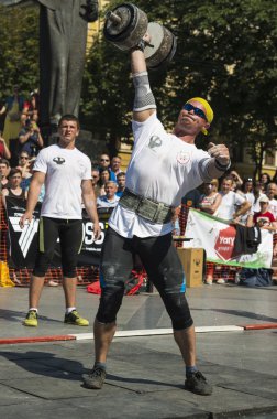 Strongman competitions raises dumbbell hand