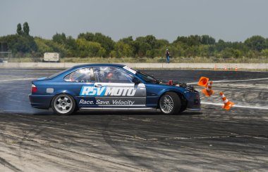 Unknown rider on the car brand BMW   makes a mistake on the trac