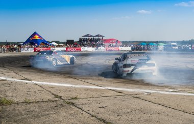 Unknown riders on the cars brand Nissan   overcomes the track