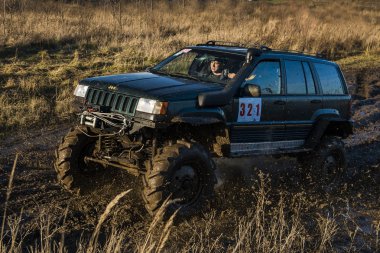 Off-road vehicle brand Jeep Cherokee   overcomes the track clipart