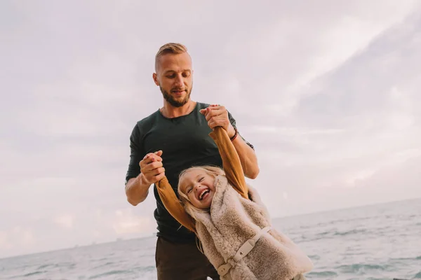 Baby girl smiling and playing with father. — Stock Photo, Image