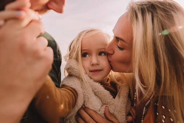 Mother, dad and daughter on the sea.