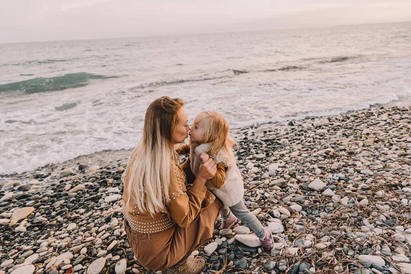 Madre con hija al lado del mar. Imágenes De Stock Sin Royalties Gratis