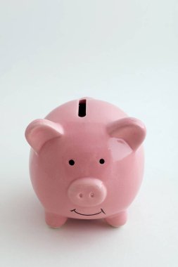 İzole edilmiş beyaz arka planda domuz şeklinde bir kumbara.