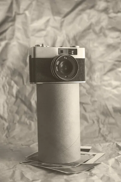 Vintage film camera on crumpled paper background