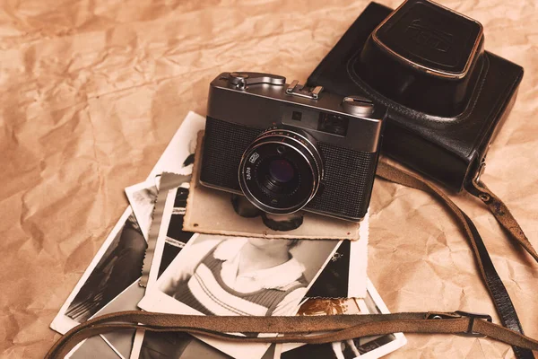 Vintage film camera on crumpled paper background
