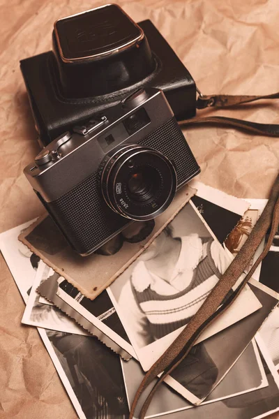 Vintage film camera on crumpled paper background