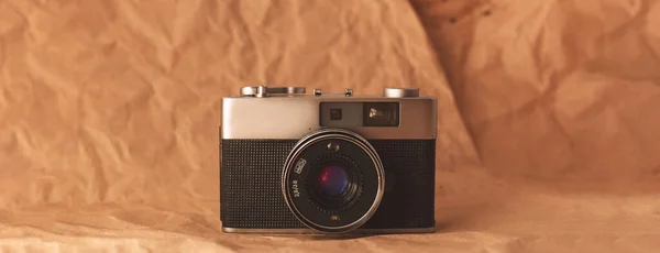 Panorama Vintage film camera on crumpled paper background