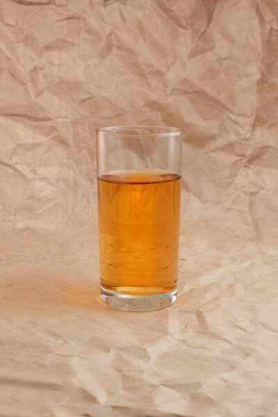 a glass of apple juice with apples