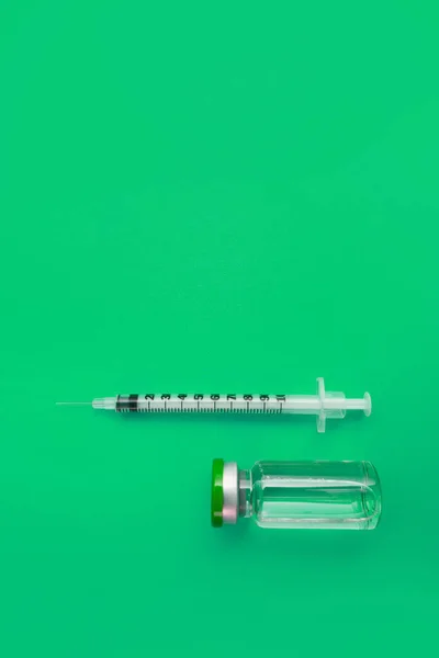 stock image syringe ampoule with medicine on green background