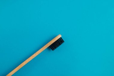 Mavi arkaplanda ahşap diş fırçası