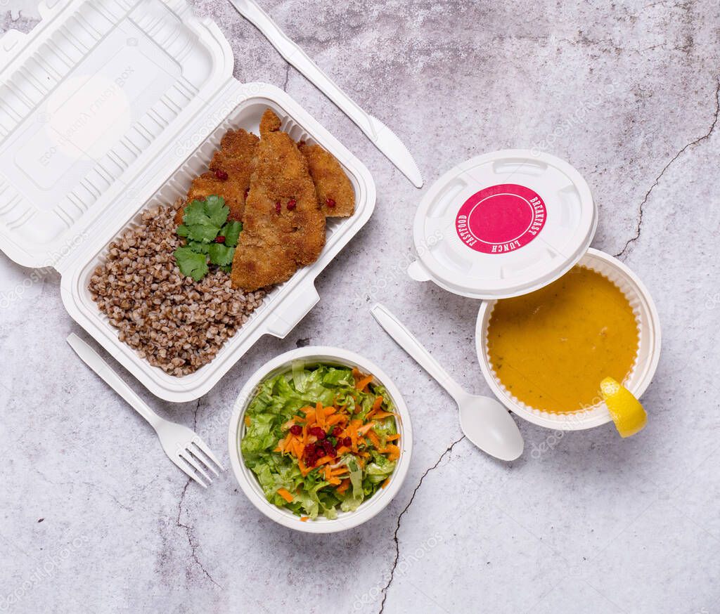 Business lunch in eco plastic container ready for delivery.Top view. Office Lunch boxes with food ready to go. Food takes away. Catering, brakfast