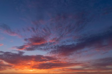 Beautiful clouds on the blue sky after sunset. Blue hour. View over the horizon
