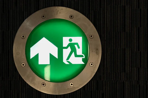 A green fire sign on the building floor