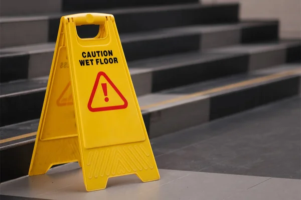 yellow sign of caution reserve cleaning on the wet floor