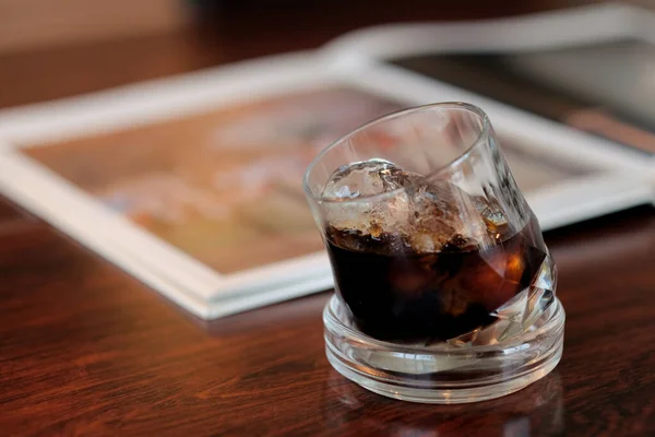 A glass of ice black coffee in coffee cafe